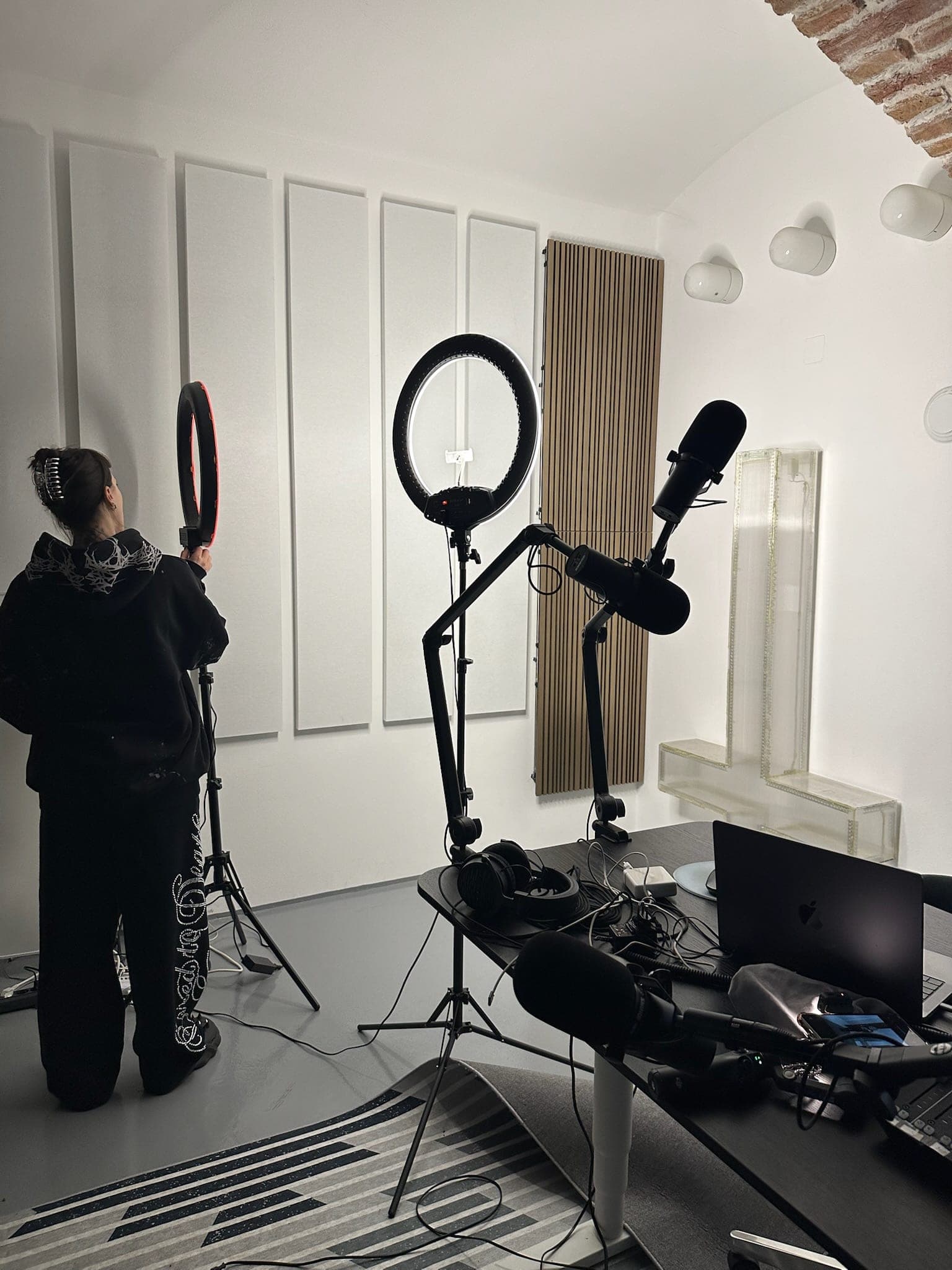 The set-up for a shoot: two ring lights, microphone and camera in the empty room.