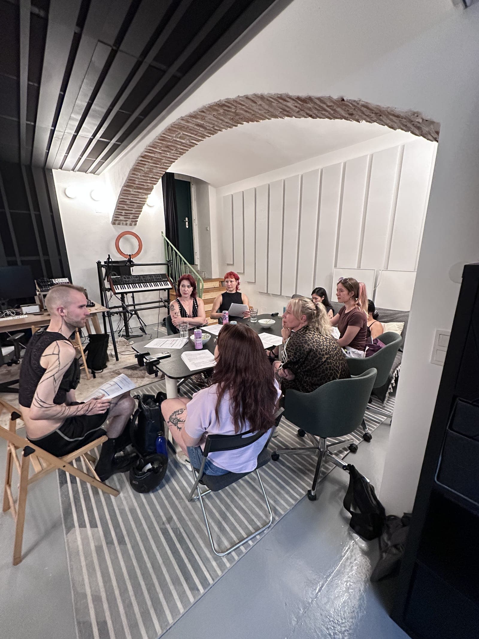 The course group under the brick arch of the studio.
